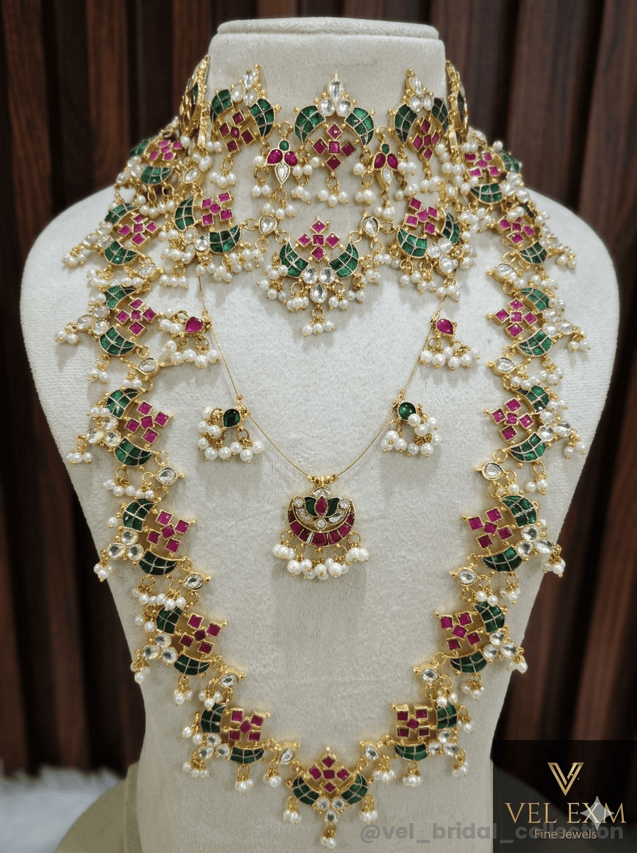 Jadau Kundan bridal set and peacock theme with ruby-red and emerald-green stones.